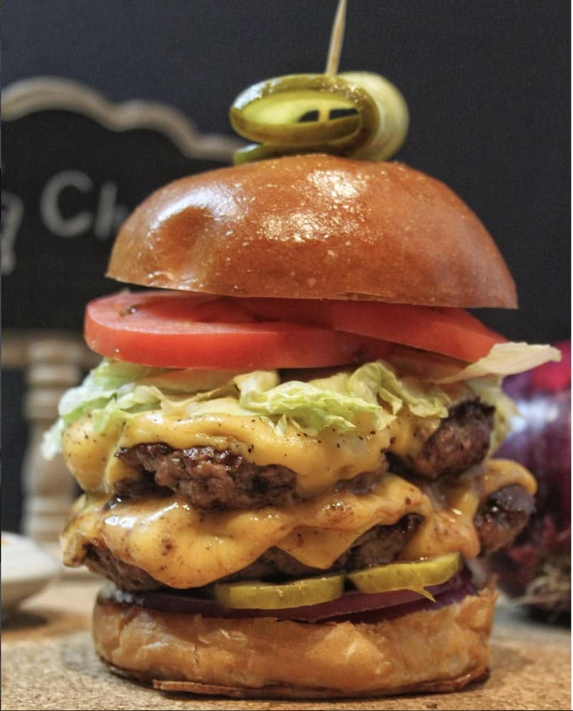 Double cheeseburger with tomato, lettuce and pickles
